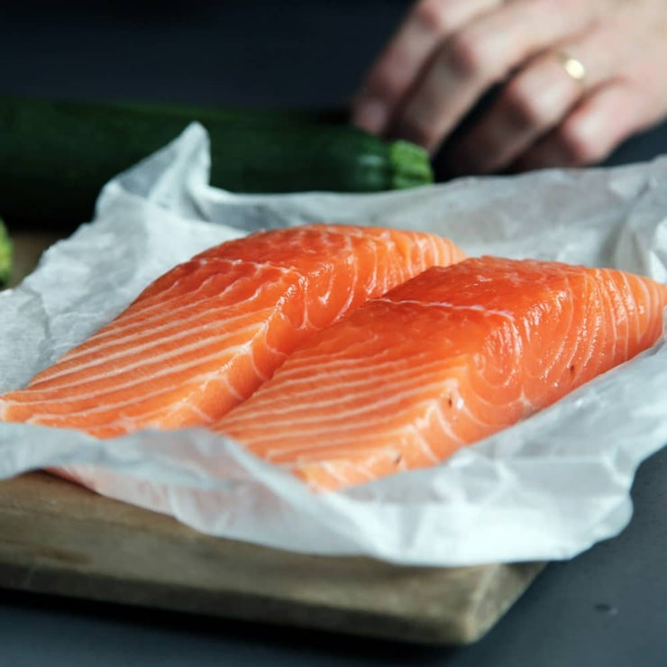 Fresh Salmon filets laid out on some butcher paper for Salmon Oil for Dogs.